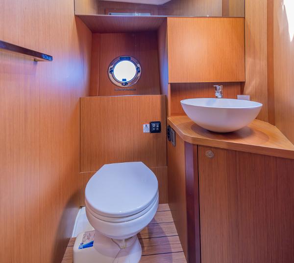 Slide: The Image of Modern bathroom in 2021 Beneteau Swift Trawler 41 with wooden finish and round porthole. - 24
