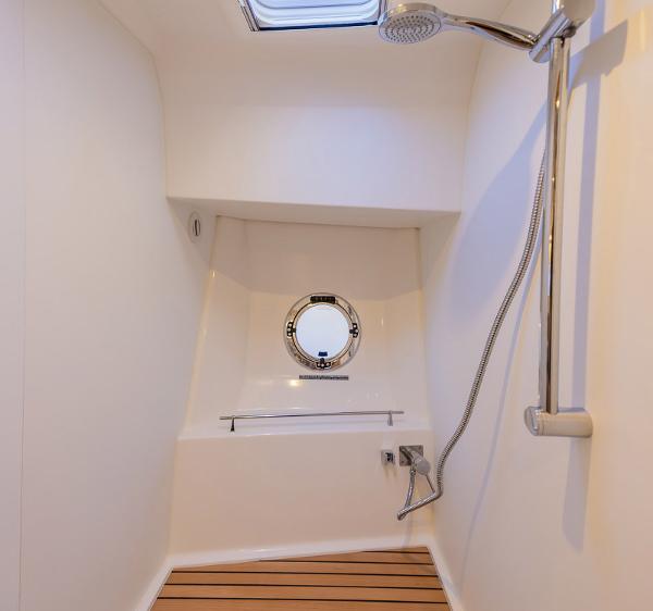 Slide: The Image of Shower area in 2021 Beneteau Swift Trawler 41 with porthole and wooden floor. - 26