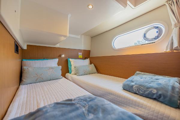 Slide: The Image of Interior cabin of 2021 Beneteau Swift Trawler 41 with twin beds and nautical decor. - 27