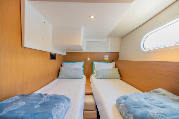Slide: The Image of 2021 Beneteau Swift Trawler 41 cabin with twin beds and modern interior design. - 28