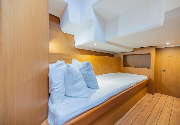 Slide: The Image of Interior cabin of 2021 Beneteau Swift Trawler 41 with wooden finish and cozy bedding. - 29