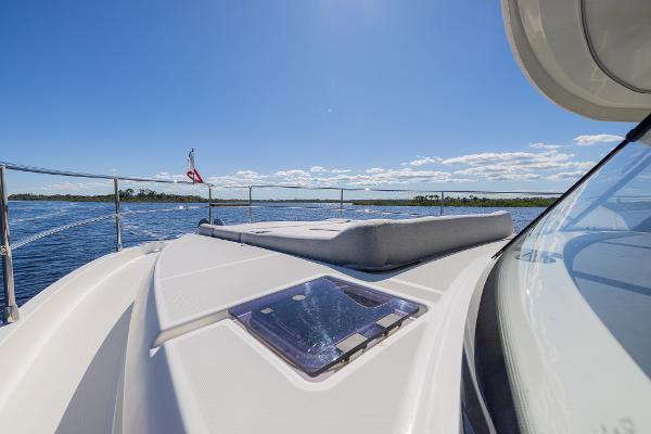 Slide: The Image of 2021 Beneteau Swift Trawler 41 cruising on open water under clear blue skies. - 34