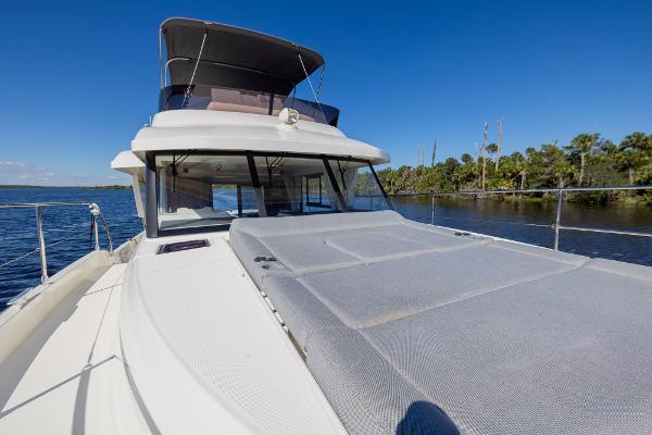 Slide: The Image of 2021 Beneteau Swift Trawler 41 on water, featuring spacious deck and sleek design. - 35