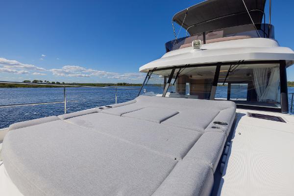 Slide: The Image of 2021 Beneteau Swift Trawler 41 on water, featuring spacious deck and clear blue sky. - 36