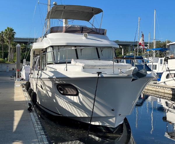 Slide: The Image of 2021 Beneteau Swift Trawler 41 docked at marina, showcasing sleek design and modern features. - 4