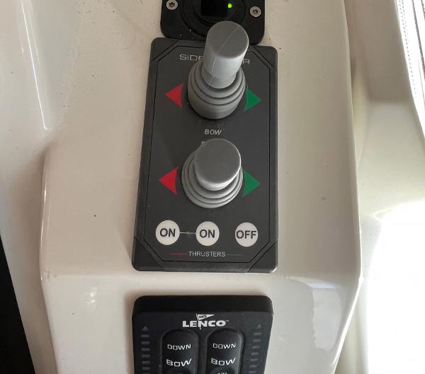 Slide: The Image of Control panel of a 2021 Beneteau Swift Trawler 41 with thruster and trim tab controls. - 43