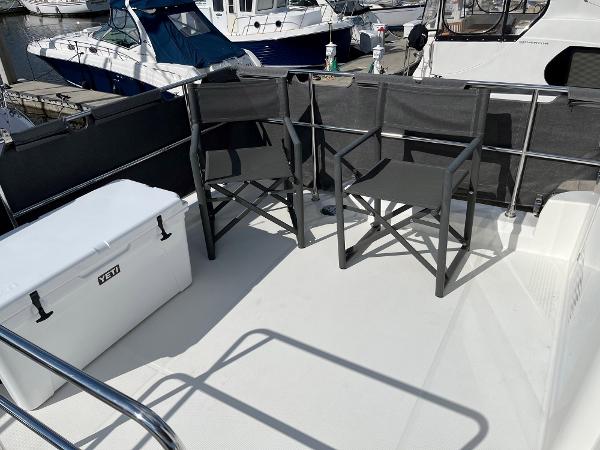 Slide: The Image of Deck of 2021 Beneteau Swift Trawler 41 with chairs and Yeti cooler. - 45