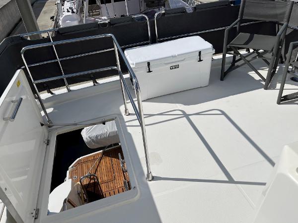 Slide: The Image of 2021 Beneteau Swift Trawler 41 deck with Yeti cooler and seating area. - 46