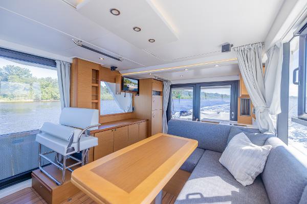 Slide: The Image of Interior of 2021 Beneteau Swift Trawler 41, featuring modern seating and large windows. - 7