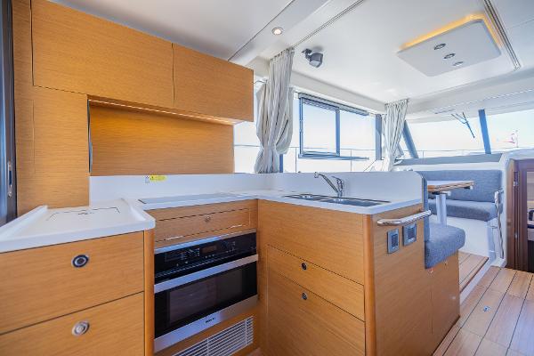 Slide: The Image of Interior of 2021 Beneteau Swift Trawler 41, featuring modern kitchen and seating area. - 9