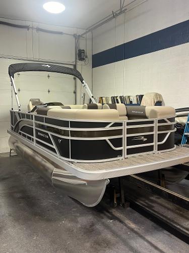 Slide: The Image of 2025 Bennington 188 SL pontoon boat in a garage setting. - 2