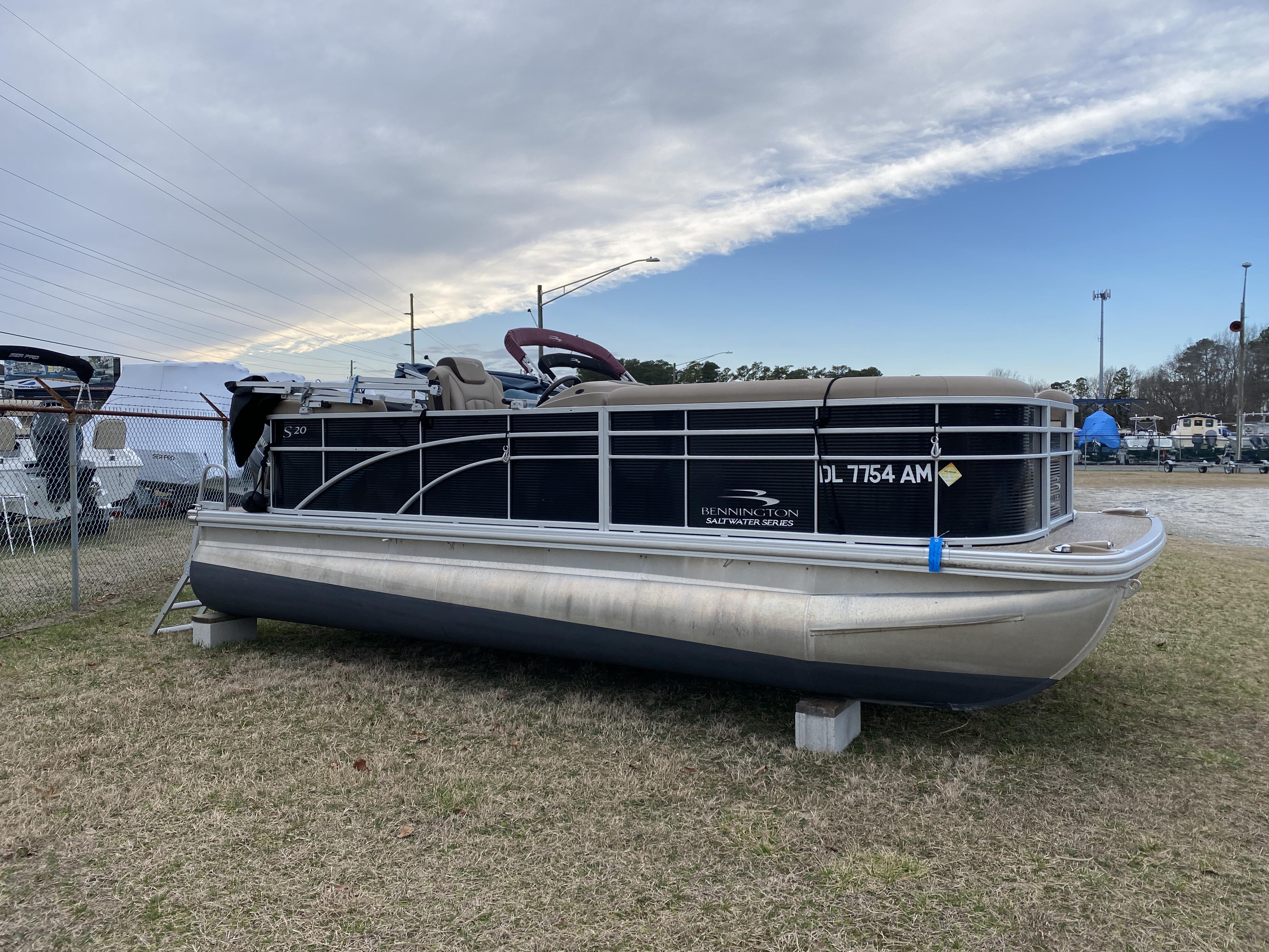 Slide: The Image of 2021 Bennington 20 SSR pontoon boat on display outdoors. - 1