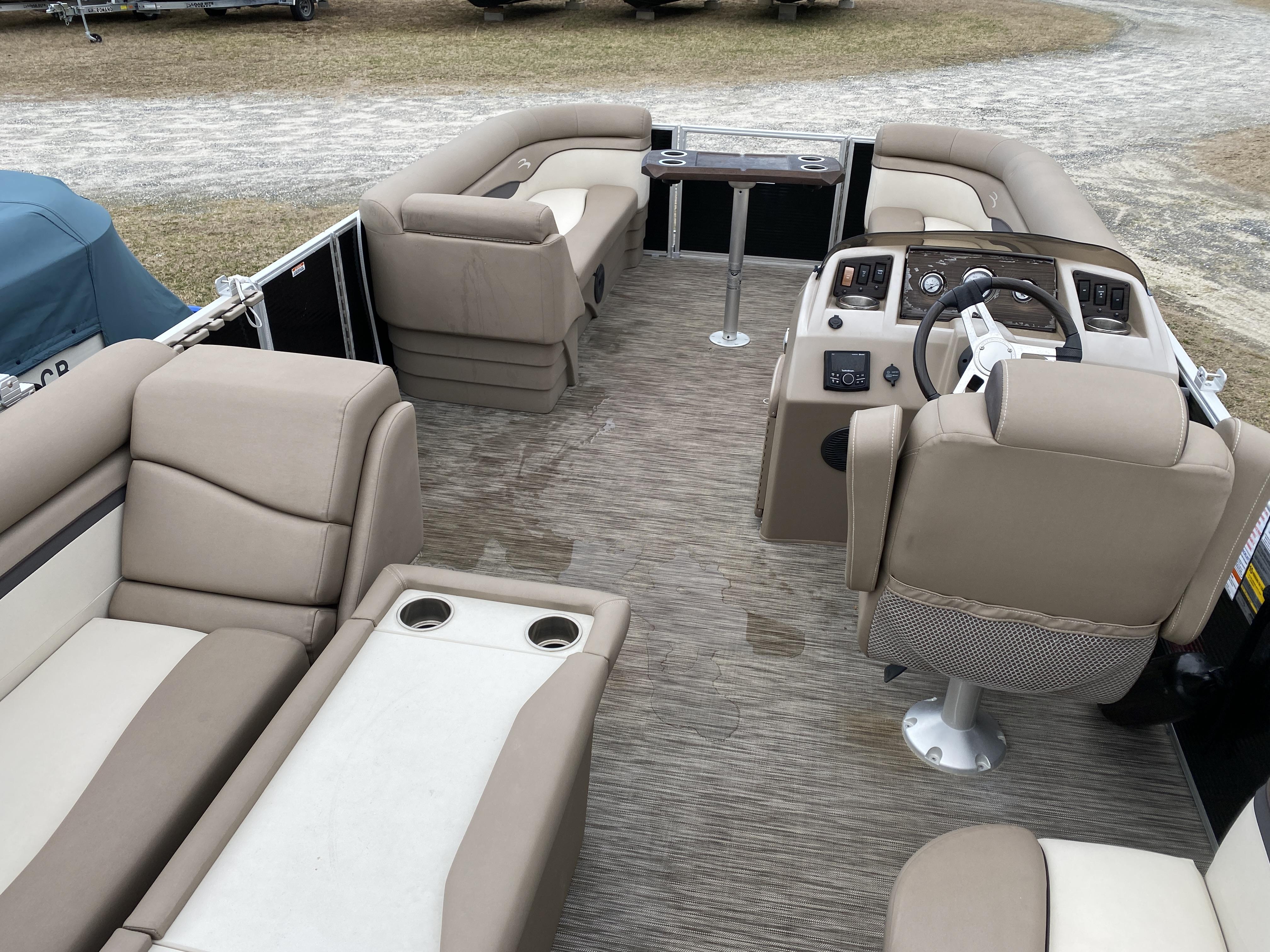 Slide: The Image of 2021 Bennington 20 SSR pontoon boat interior with beige seating and helm. - 3