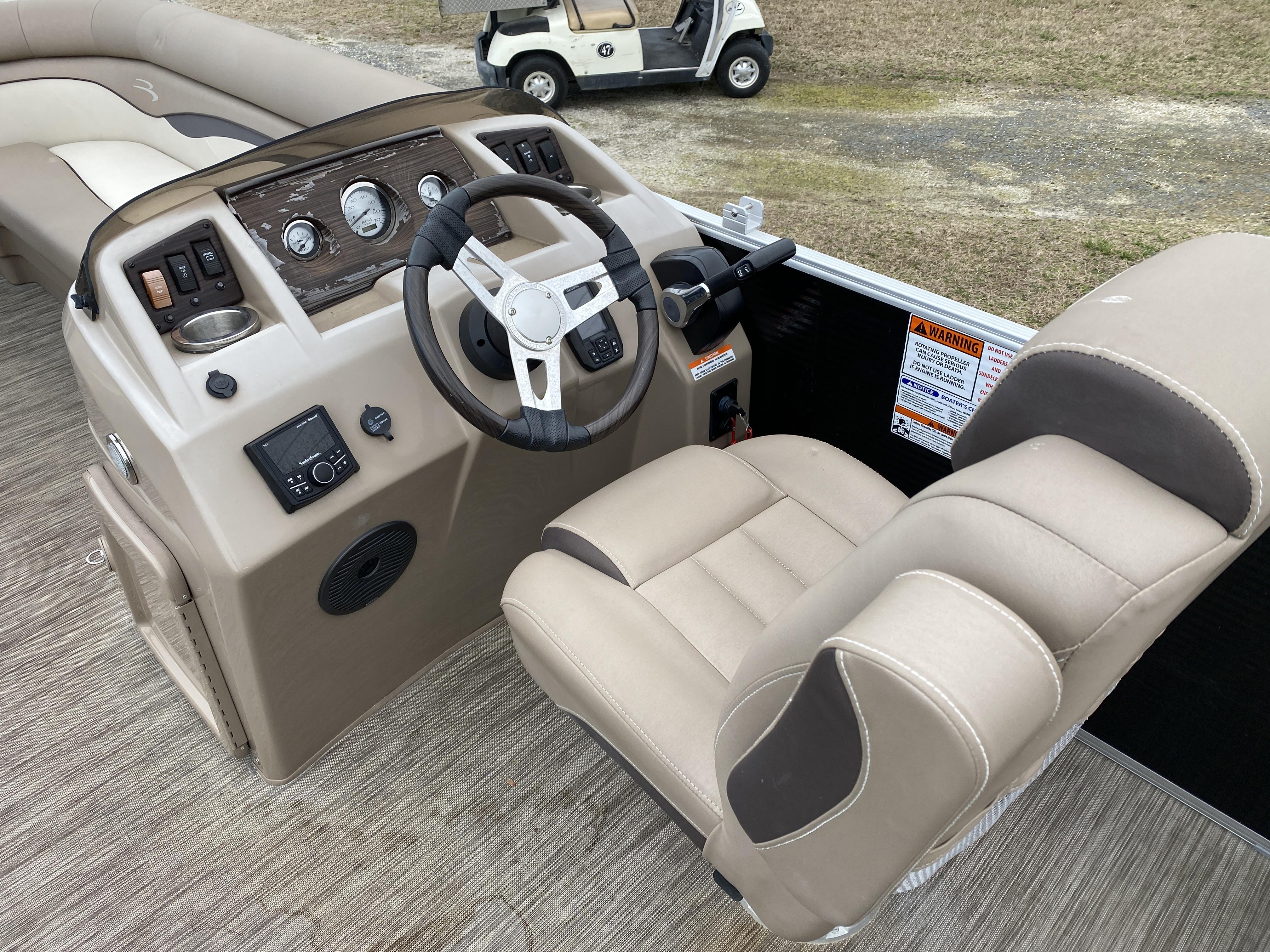 Slide: The Image of 2021 Bennington 20 SSR boat cockpit with steering wheel and control panel. - 8
