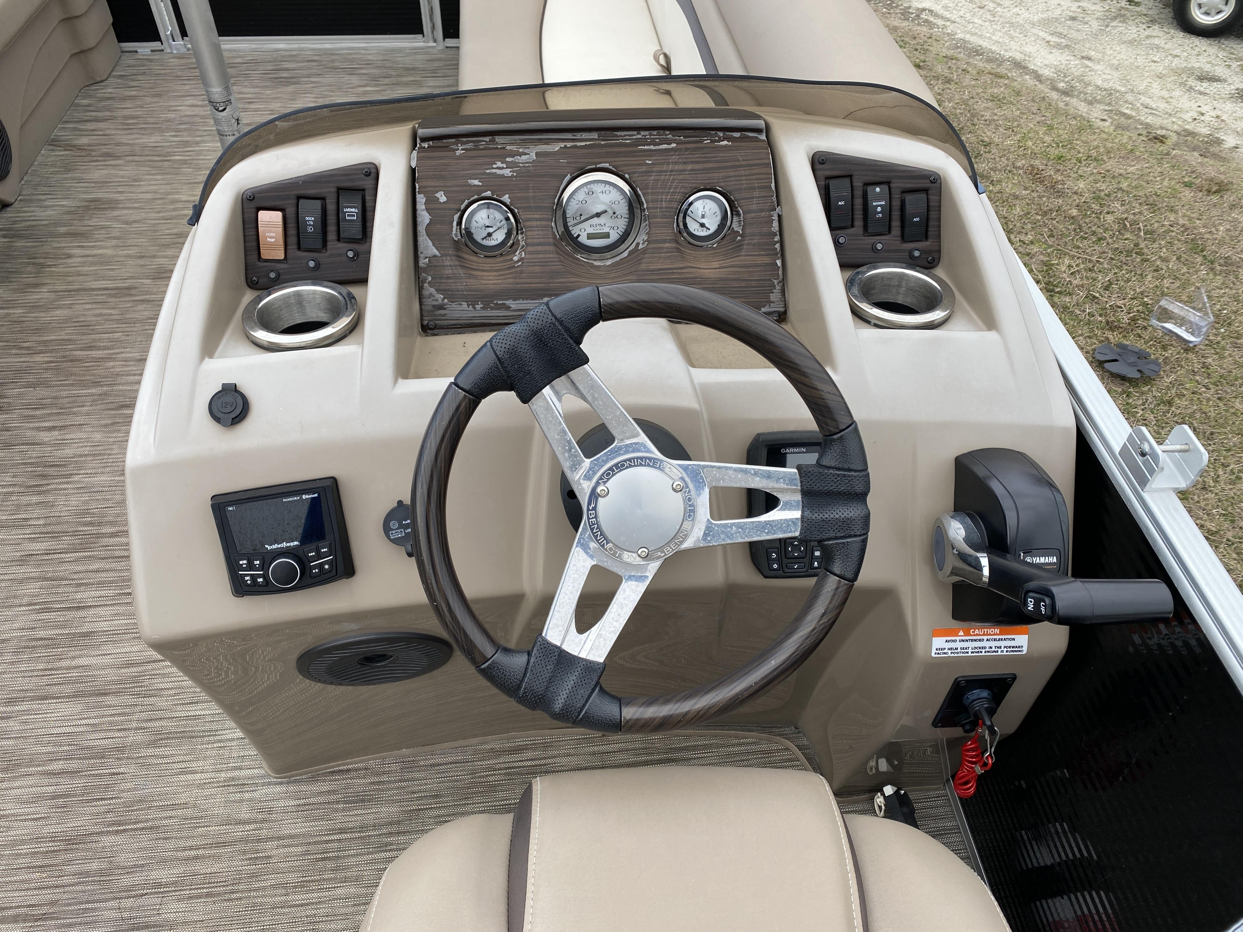 Slide: The Image of 2021 Bennington 20 SSR boat dashboard with steering wheel, controls, and gauges. - 9