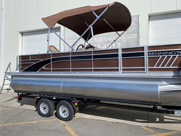 Slide: The Image of 2023 Bennington 22LFAPG pontoon boat on a trailer with a brown canopy. - 1