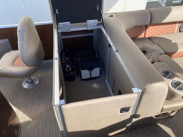Slide: The Image of 2023 Bennington 22LFAPG pontoon boat with open storage compartment and seating area. - 10
