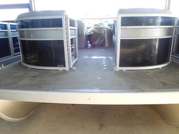 Slide: The Image of 2023 Bennington 22 SLX pontoon boat, front view, docked in a covered area. - 2