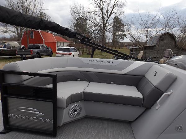 Slide: The Image of 2023 Bennington 22 SXSR pontoon boat with gray seating and outdoor background. - 10