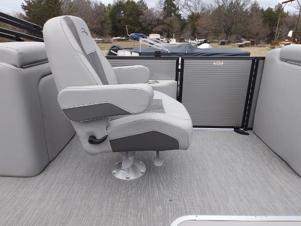 Slide: The Image of 2023 Bennington 22 SXSR boat interior with a comfortable captain's chair. - 14