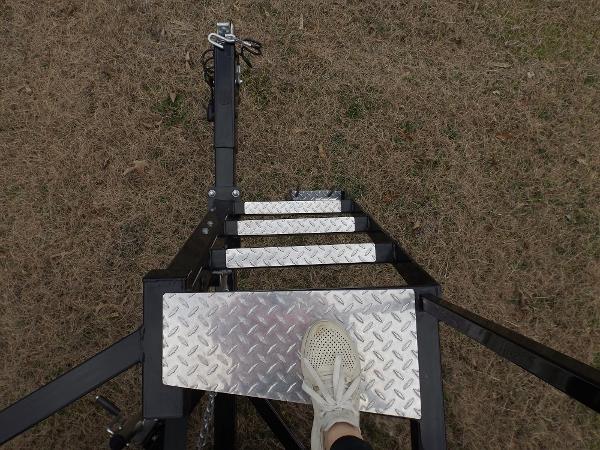 Slide: The Image of 2023 Bennington 22 SXSR boat trailer steps with foot on metal platform. - 3