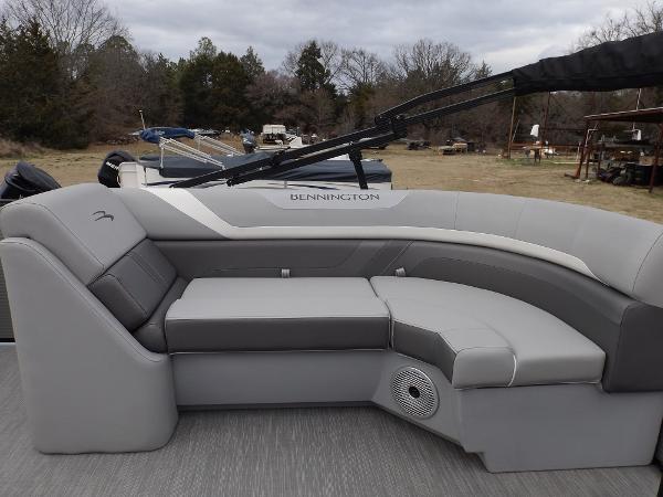 Slide: The Image of 2023 Bennington 22 SXSR boat with gray seating and outdoor background. - 9