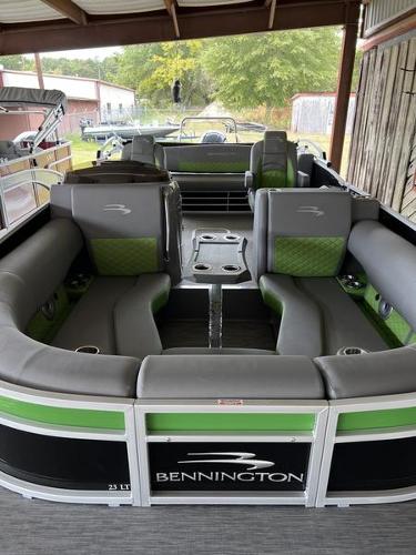 Slide: The Image of 2023 Bennington 23LTSB pontoon boat with green and gray seating. - 1