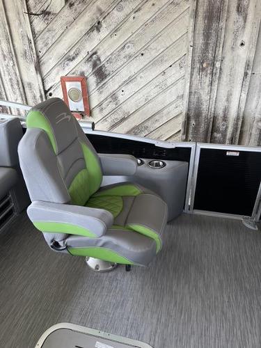 Slide: The Image of 2023 Bennington 23LTSB boat captain's chair with green and gray upholstery. - 10