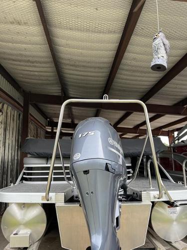 Slide: The Image of 2023 Bennington 23LTSB pontoon boat with Yamaha 175 outboard motor in storage. - 11