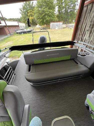 Slide: The Image of 2023 Bennington 23LTSB pontoon boat interior with gray and green seating. - 2