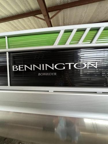 Slide: The Image of 2023 Bennington 23LTSB Bowrider pontoon boat with green and black detailing. - 6