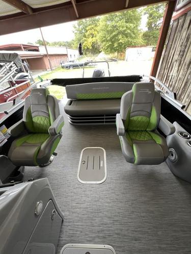 Slide: The Image of 2023 Bennington 23LTSB pontoon boat interior with green and gray seating. - 9