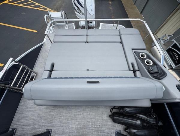 Slide: The Image of 2023 Bennington 25 QSBA boat with spacious gray seating and cup holders on deck. - 14