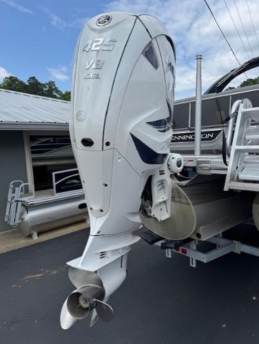 Slide: The Image of 2023 Bennington 25 QSBA with powerful 425 V8 outboard engine, docked on trailer. - 18