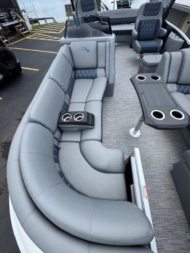 Slide: The Image of 2023 Bennington 25 QSBA pontoon boat with luxurious gray seating and cup holders. - 5