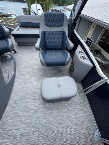Slide: The Image of 2023 Bennington 25 QSBA boat interior with plush seating and cup holders. - 6