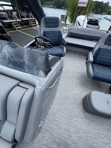 Slide: The Image of 2023 Bennington 25 QSBA pontoon boat interior with plush seating and modern design. - 7