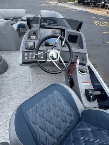Slide: The Image of 2023 Bennington 25 QSBA boat interior with steering wheel and control panel. - 9
