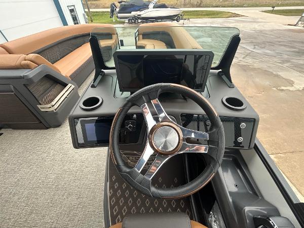 Slide: The Image of 2025 Bennington M26 boat dashboard with modern steering wheel and digital displays. - 7