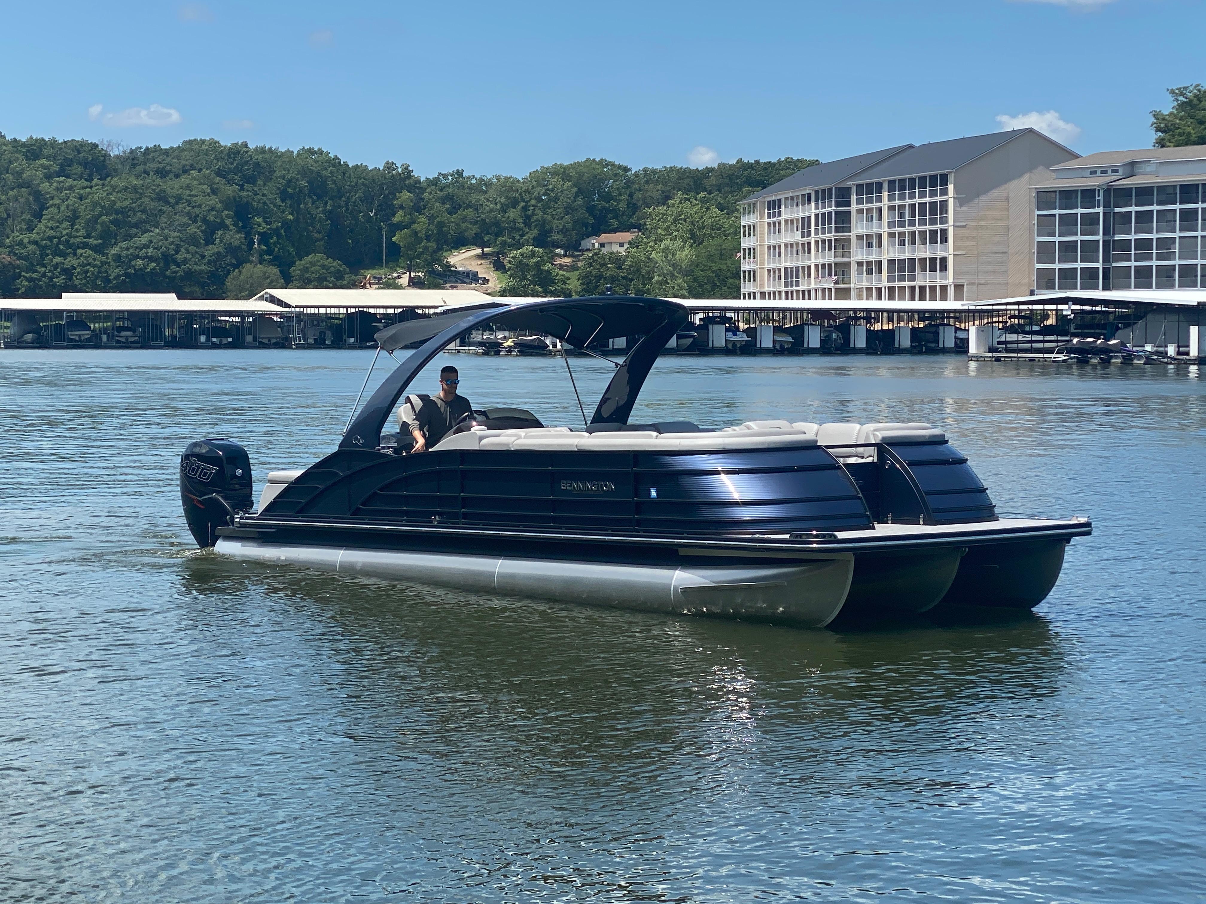 Slide: The Image of 2020 Bennington 30 QSBAX2 pontoon boat on a scenic lake. - 1