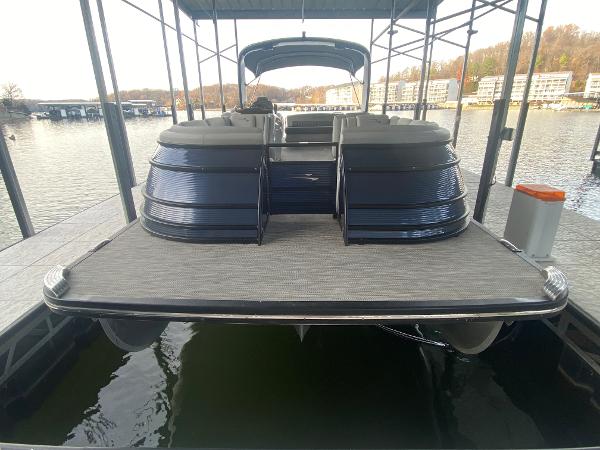 Slide: The Image of 2020 Bennington 30 QSBAX2 pontoon boat docked on a calm lake. - 12