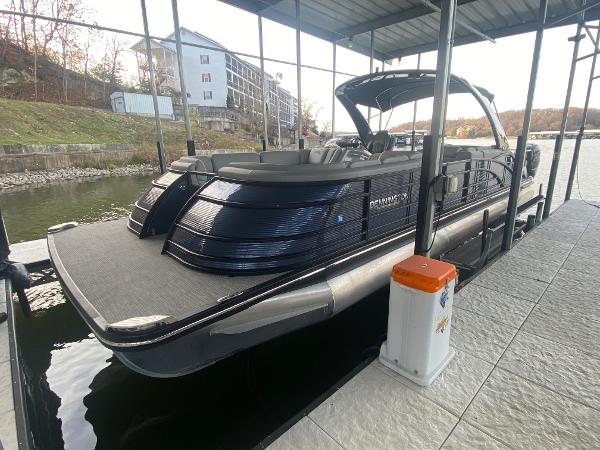 Slide: The Image of 2020 Bennington 30 QSBAX2 pontoon boat docked in a covered marina. - 13