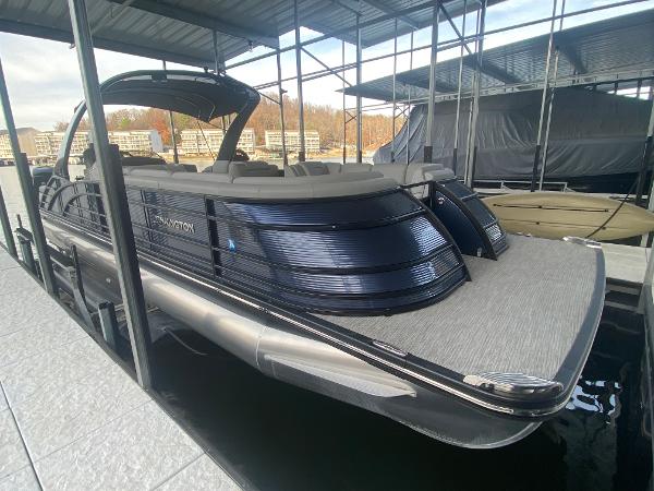 Slide: The Image of 2020 Bennington 30 QSBAX2 pontoon boat docked under a covered marina. - 15