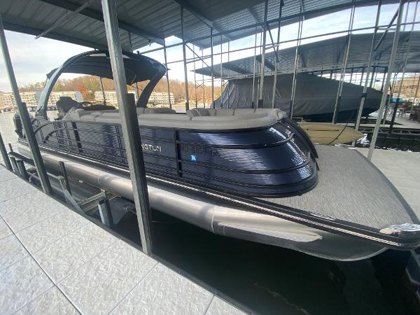 Slide: The Image of 2020 Bennington 30 QSBAX2 pontoon boat docked under a covered marina. - 16