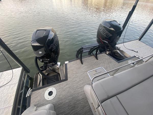 Slide: The Image of 2020 Bennington 30 QSBAX2 boat with dual outboard motors on a calm lake. - 18