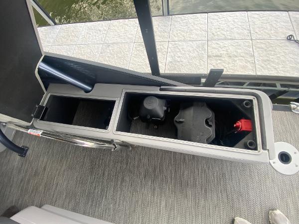 Slide: The Image of 2020 Bennington 30 QSBAX2 boat storage compartments with battery and equipment. - 21