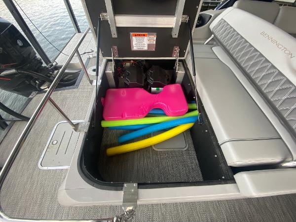 Slide: The Image of 2020 Bennington 30 QSBAX2 boat storage with colorful pool noodles and pink float. - 24