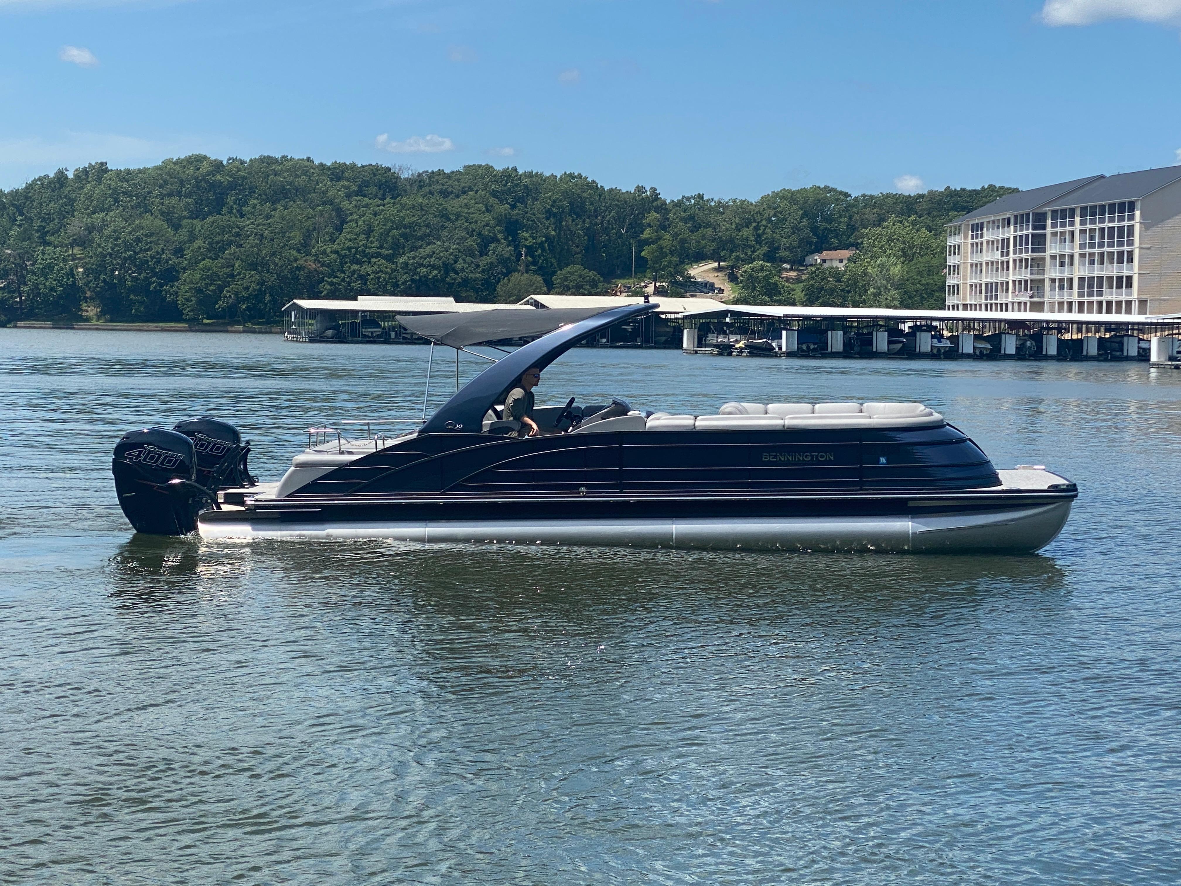 Slide: The Image of 2020 Bennington 30 QSBAX2 pontoon boat on a calm lake with scenic background. - 3