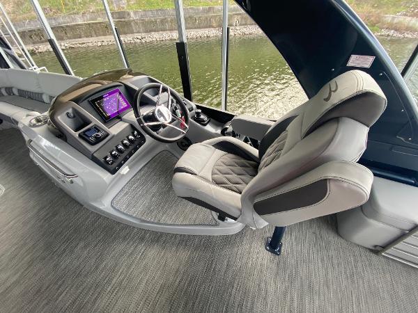 Slide: The Image of Captain's helm of 2020 Bennington 30 QSBAX2 boat with modern controls and plush seating. - 36