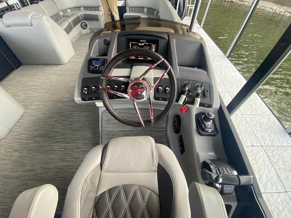 Slide: The Image of 2020 Bennington 30 QSBAX2 boat helm with modern controls and luxurious seating. - 39